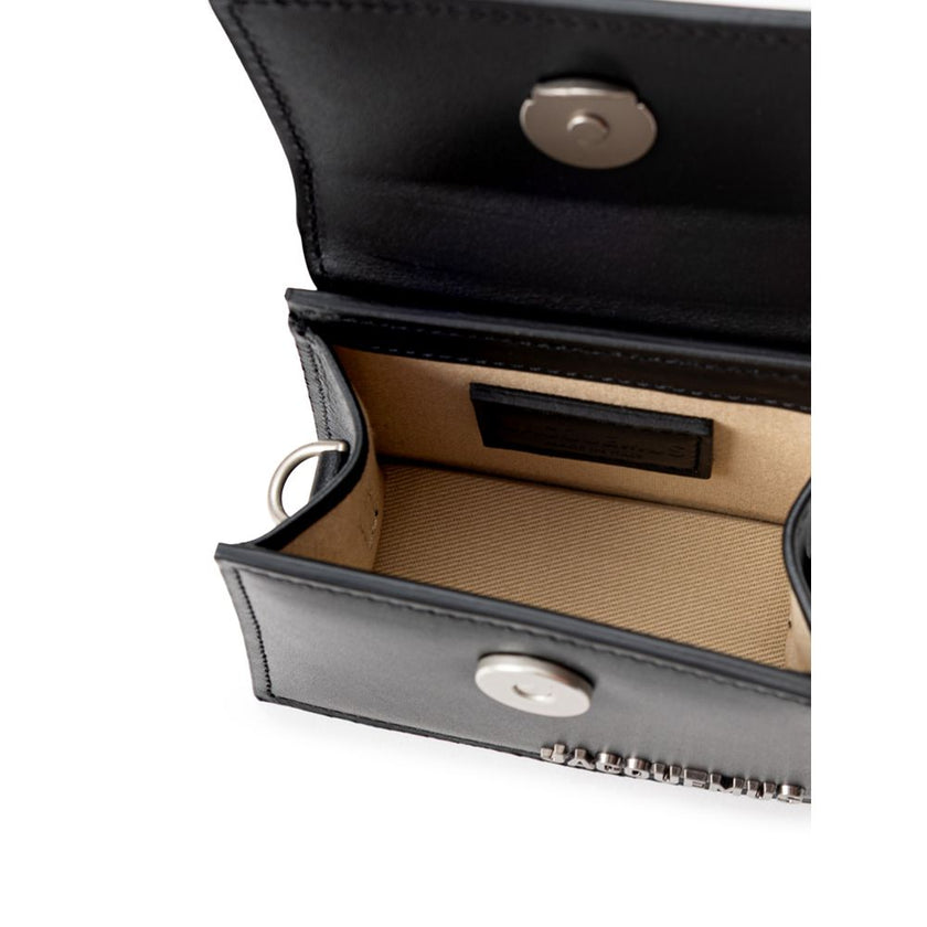 Black Leather HandbagJacquemus Black Leather Mini Le Chiquito Bag. In black leather, front opening with hidden snap button, single compartment. Silver metal logo on the side. Composition: 100% Leather Internal SKU: 25MG114 Brand SKU: 216BA0013061990Black