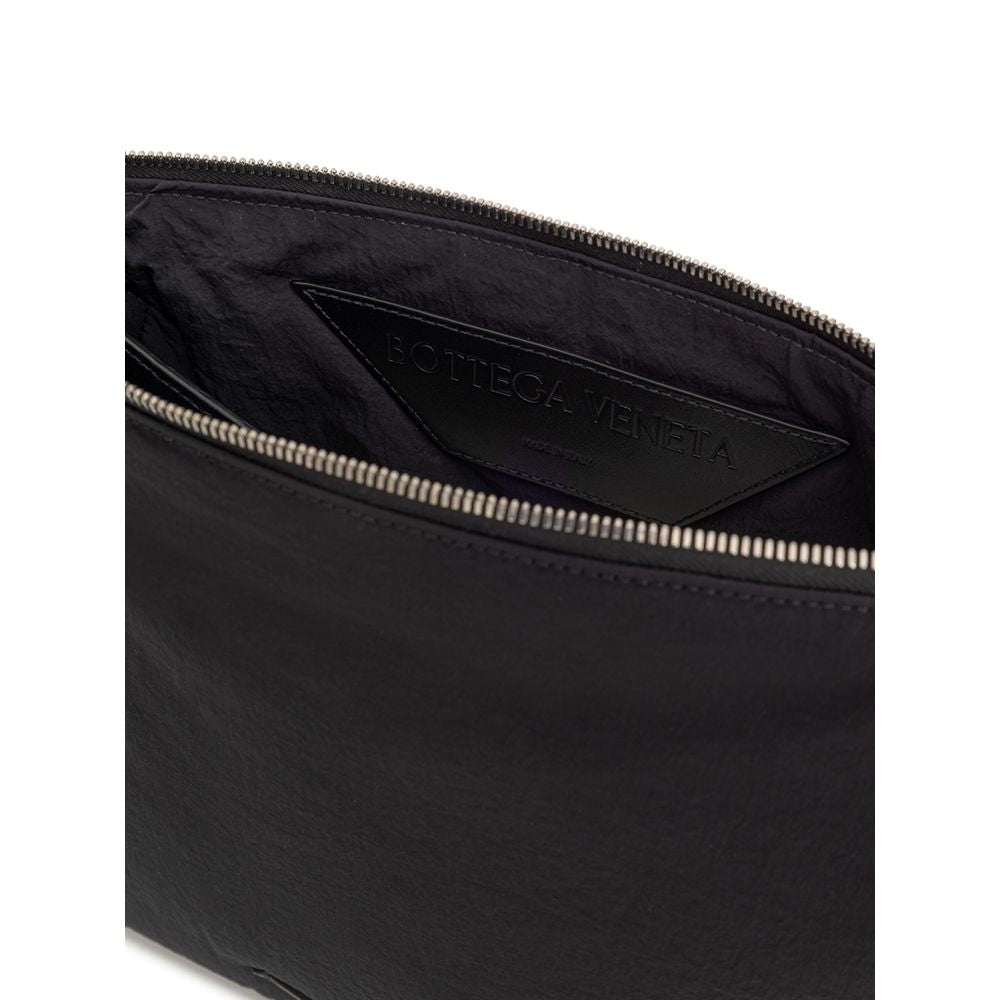 Black Nylon Clutch BagBottega Veneta Black Nylon Light Paper Clutch. Padded nylon clutch bag, top zip opening and leather pull. Single compartment, inside pocket. Leather tag with tone-on-tone printed logo, removable leather handle with woven motif. Compo