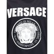 Black Cotton T-ShirtCotton T-Shirt by Versace featuring a ribbed crew neck and iconic contrasting monogram on the front, embellished with a Medusa maxi head. A distinctive garment that combines comfort and bold style. Season: AW25 Fit: Regular Composition