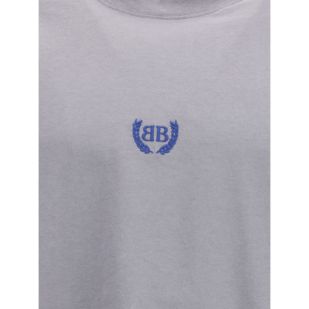 Gray Cotton T-ShirtBalenciaga’s cotton T-Shirt features a classic ribbed crew neck and the iconic BB logo embroidered on the front, adding a distinctive touch of luxury. The vintage worn-effect design gives the T-shirt a unique look, as if it has already