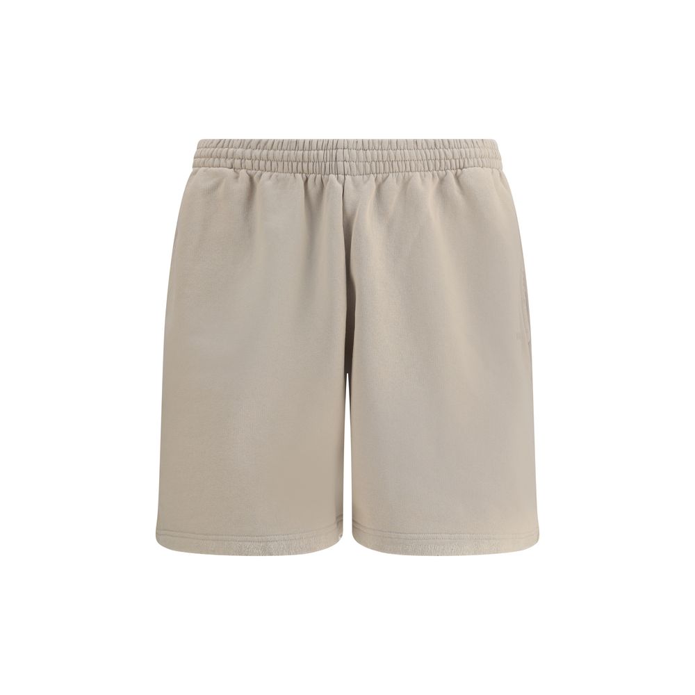 Beige Cotton Bermuda ShortsCotton tracksuit Shorts by Balenciaga feature an elasticized waistband and adjustable inner drawstring for personalized comfort. They feature two American-style side pockets and are embellished with the iconic tone-on-tone embro