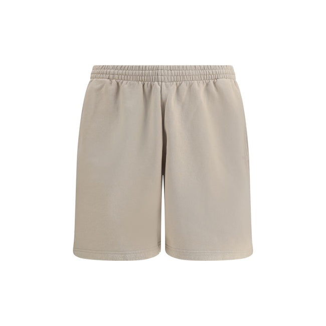 Beige Cotton Bermuda ShortsCotton tracksuit Shorts by Balenciaga feature an elasticized waistband and adjustable inner drawstring for personalized comfort. They feature two American-style side pockets and are embellished with the iconic tone-on-tone embro
