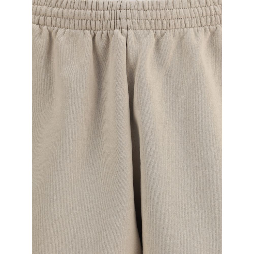 Beige Cotton Bermuda ShortsCotton tracksuit Shorts by Balenciaga feature an elasticized waistband and adjustable inner drawstring for personalized comfort. They feature two American-style side pockets and are embellished with the iconic tone-on-tone embro