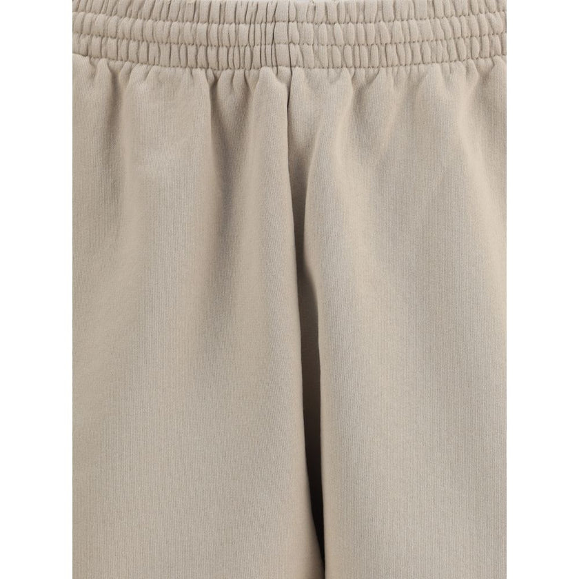 Beige Cotton Bermuda ShortsCotton tracksuit Shorts by Balenciaga feature an elasticized waistband and adjustable inner drawstring for personalized comfort. They feature two American-style side pockets and are embellished with the iconic tone-on-tone embro