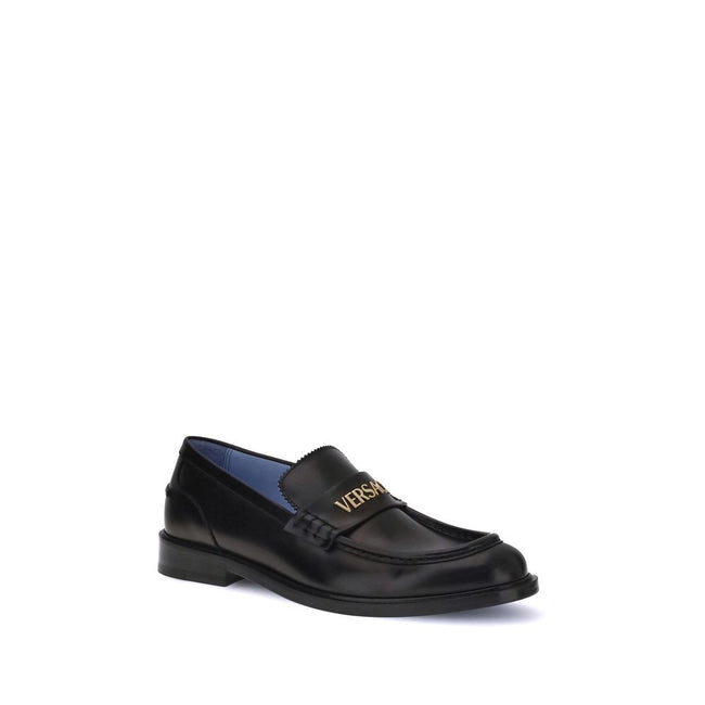 Black Calf Leather Bos Taurus Slip-On LoafersVersace’s Leather Loafers combine elegance and practicality in a slip-on design. Featuring a rounded toe, they feature the gold logo applied to the front tray, giving a distinctive and refined touch to this cla