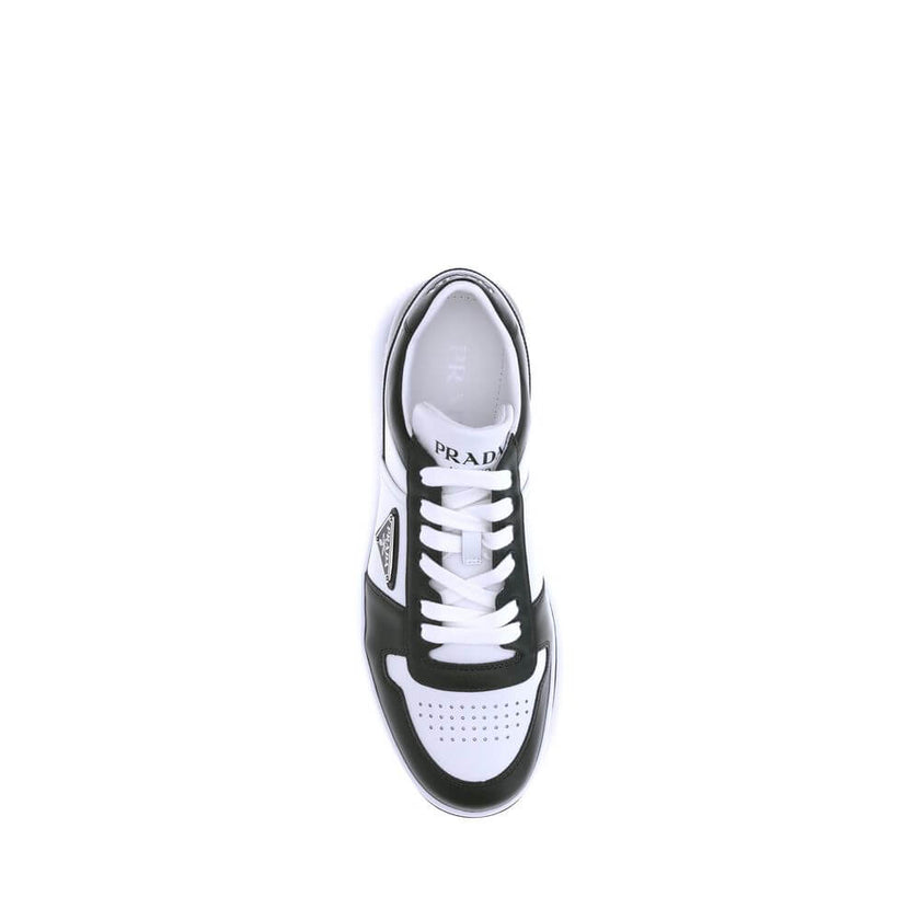Black Calf Leather Bos Taurus Low Top SneakersStylish and contemporary leather Downtown Sneakers by Prada, these sneakers feature a front lace-up closure and the brand’s signature enameled triangular logo plaque applied to the side panel. The round, perfo