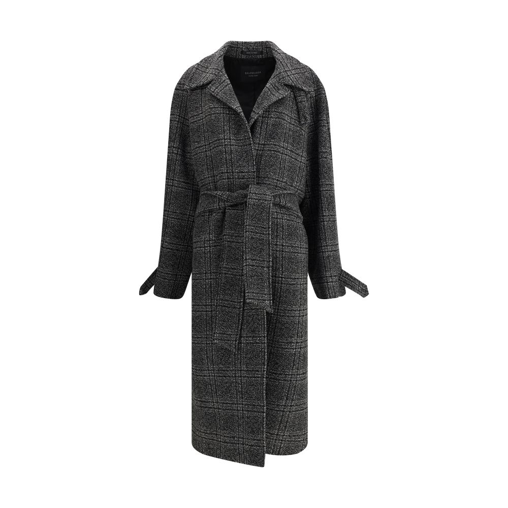 Gray Wool CoatBalenciaga’s Long Coat is a statement piece that combines elegance and character. Crafted from wool with a refined checked design, it features welt pockets on the front and distinctive details such as belt loops on the collar and sleeve. The