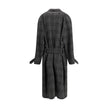 Gray Wool CoatBalenciaga’s Long Coat is a statement piece that combines elegance and character. Crafted from wool with a refined checked design, it features welt pockets on the front and distinctive details such as belt loops on the collar and sleeve. The