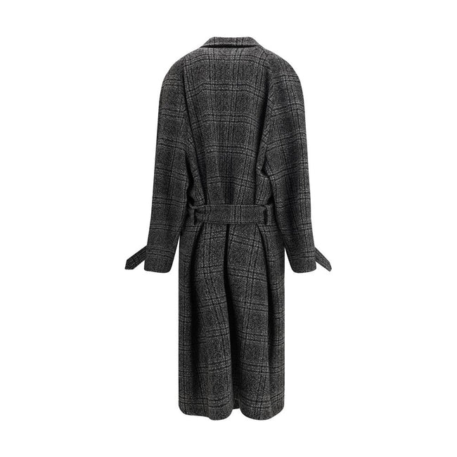 Gray Wool CoatBalenciaga’s Long Coat is a statement piece that combines elegance and character. Crafted from wool with a refined checked design, it features welt pockets on the front and distinctive details such as belt loops on the collar and sleeve. The