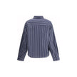 Blue Cotton Pattern ShirtThe Balenciaga Striped Shirt reinterprets a wardrobe classic with the brand’s bold aesthetic. Featuring a classic collar and a front button closure, it has an oversized design and two side vents that add movement and modernity. A