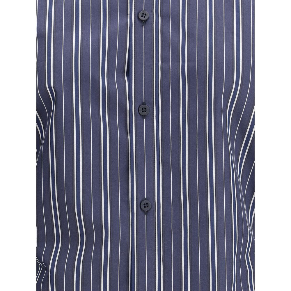 Blue Cotton Pattern ShirtThe Balenciaga Striped Shirt reinterprets a wardrobe classic with the brand’s bold aesthetic. Featuring a classic collar and a front button closure, it has an oversized design and two side vents that add movement and modernity. A