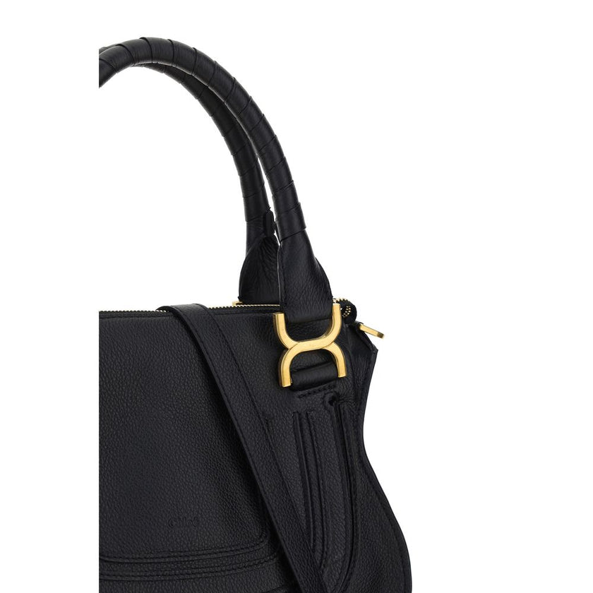Marcie HandbagCalfskin Marcie Handbag by Chloé, double rigid leather top handle, removable and adjustable leather shoulder strap, top zipper closure, front flap with iconic leather tassel detail, iconic brand monogram press-stamped on front, open front po
