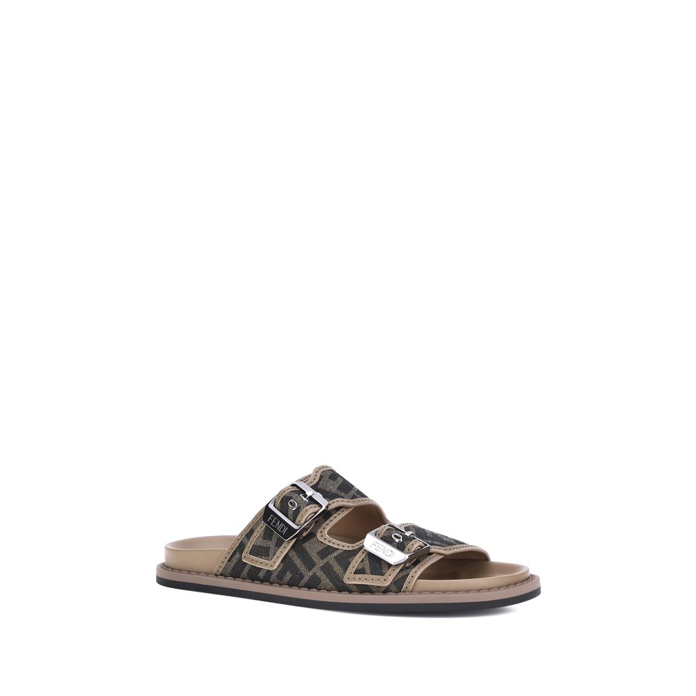 Brown Calf Leather Bos Taurus Flat SandalsLeather Sandals by Fendi with an open toe and two adjustable straps on the front, featuring a buckle. The slip-on style features a flat sole and the brand’s iconic all-over repeated FF pattern for a distinctive an