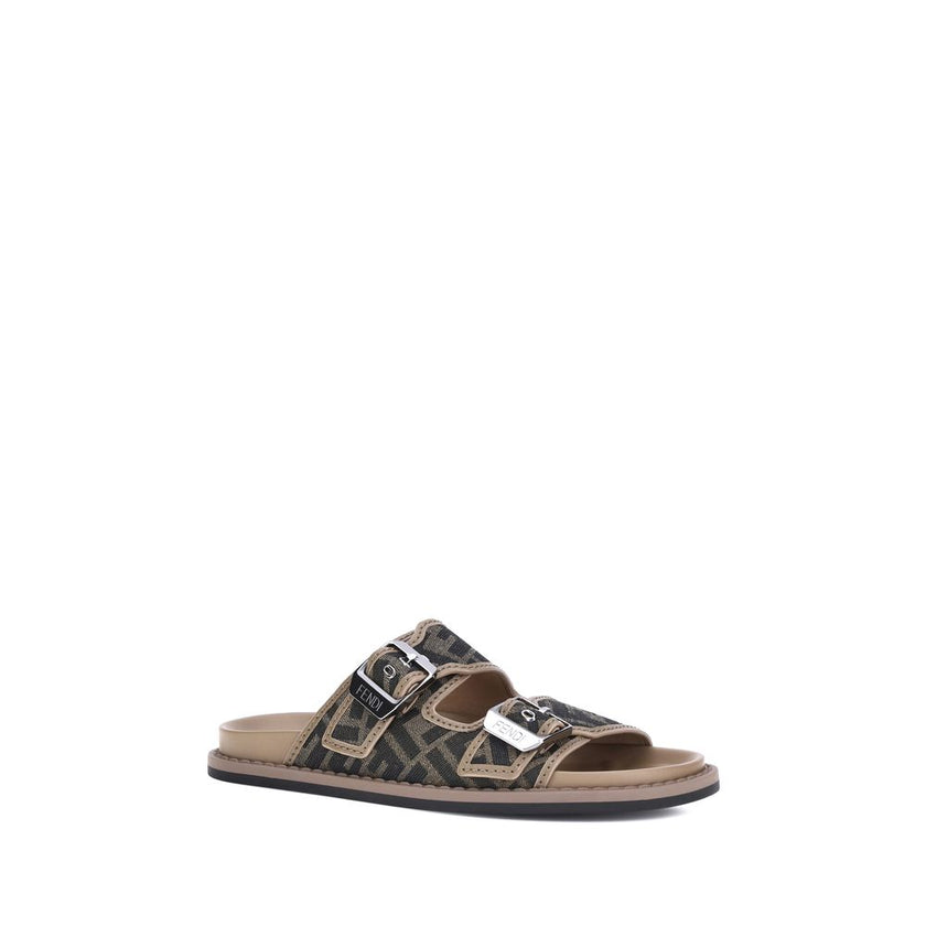 Brown Calf Leather Bos Taurus Flat SandalsLeather Sandals by Fendi with an open toe and two adjustable straps on the front, featuring a buckle. The slip-on style features a flat sole and the brand’s iconic all-over repeated FF pattern for a distinctive an