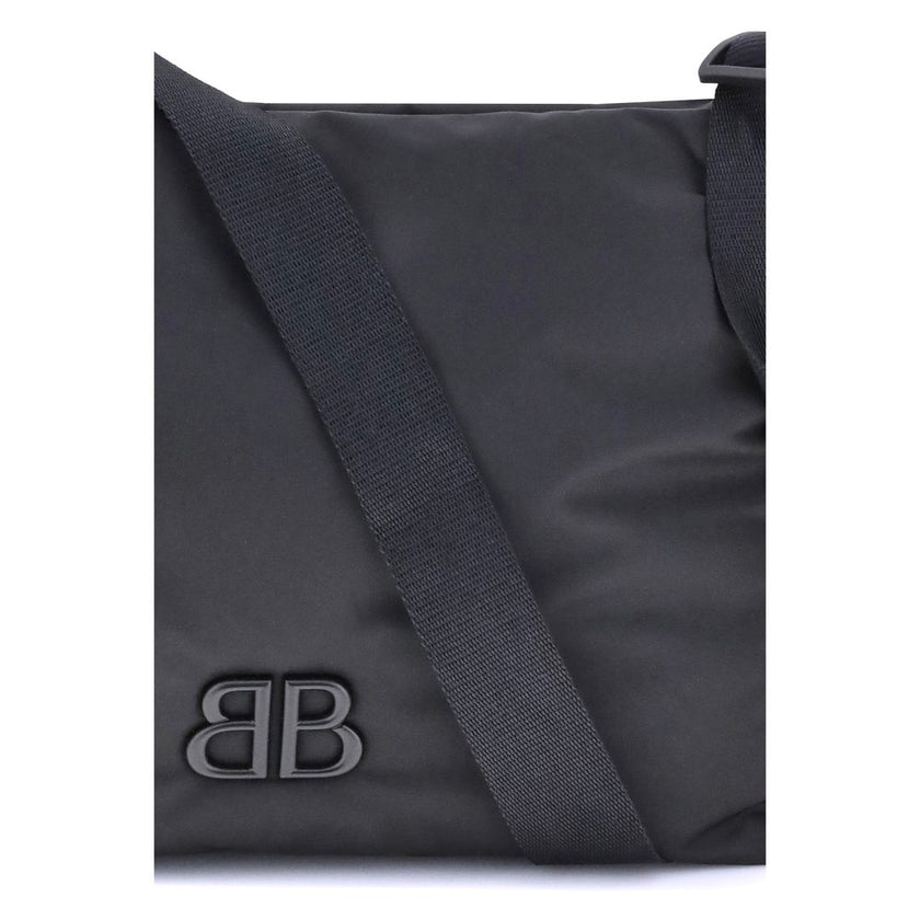 Black Fabric Shoulder BagFabric Shoulder Bag by Balenciaga with a contemporary and versatile design, ideal for everyday use. The flat shoulder strap ensures comfort and practicality, while the BB logoed magnetic flap closure adds a distinctive and prestig