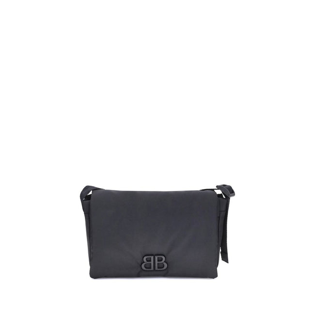 Black Polyamide Shoulder BagBalenciaga’s Monaco Shoulder Bag, made of lightweight and durable nylon, stands out for its minimalist and functional design. The top flap with magnetic closure ensures practicality, while the adjustable shoulder strap allows f
