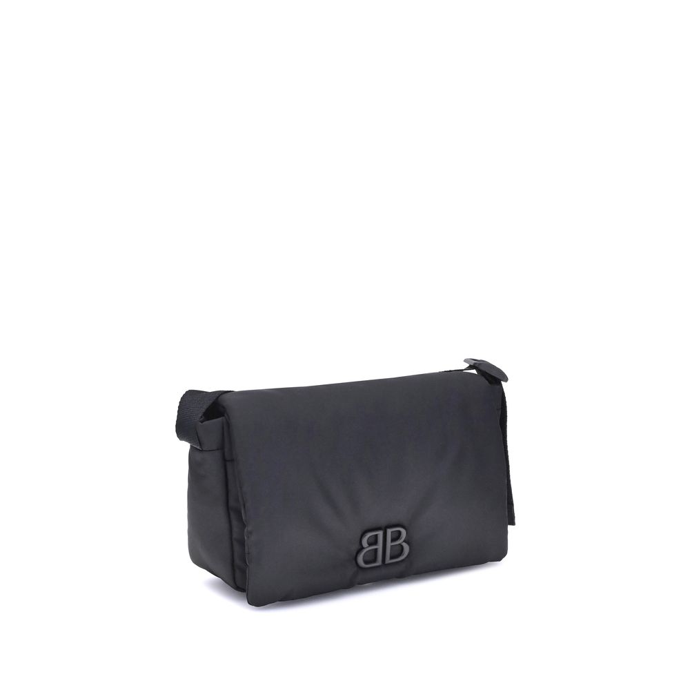 Black Polyamide Shoulder BagBalenciaga’s Monaco Shoulder Bag, made of lightweight and durable nylon, stands out for its minimalist and functional design. The top flap with magnetic closure ensures practicality, while the adjustable shoulder strap allows f