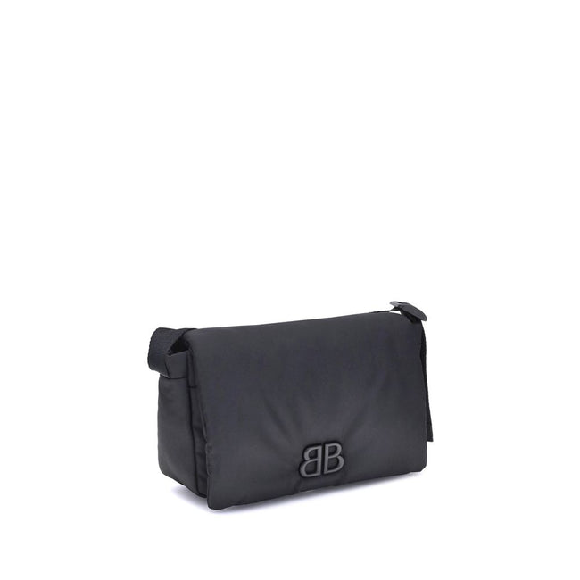 Black Polyamide Shoulder BagBalenciaga’s Monaco Shoulder Bag, made of lightweight and durable nylon, stands out for its minimalist and functional design. The top flap with magnetic closure ensures practicality, while the adjustable shoulder strap allows f