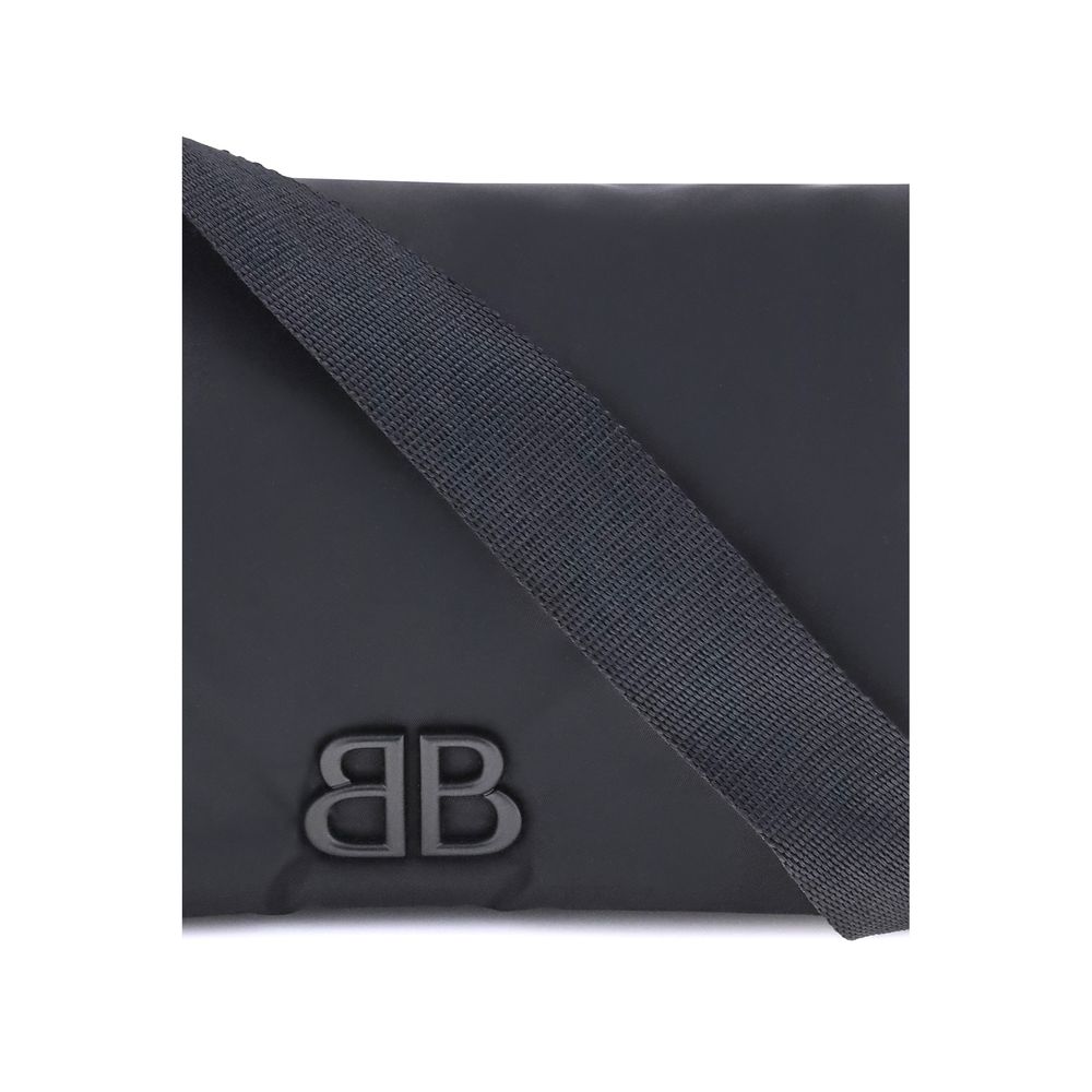 Black Polyamide Shoulder BagBalenciaga’s Monaco Shoulder Bag, made of lightweight and durable nylon, stands out for its minimalist and functional design. The top flap with magnetic closure ensures practicality, while the adjustable shoulder strap allows f