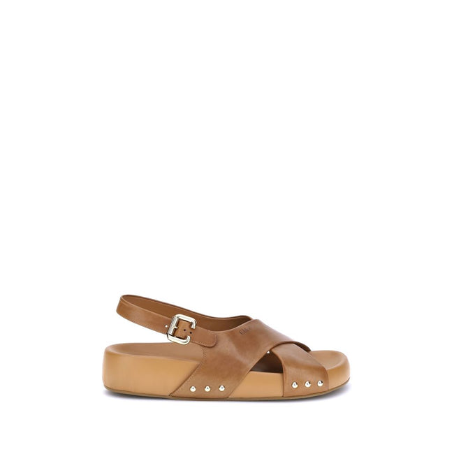 Mae SandalsThe Mae Sandals by Chloé, crafted from smooth calfskin, combine elegance and comfort thanks to the anatomical insole designed to last all day. The upper is characterized by crossed straps and an adjustable ankle strap, secured by the iconic Pad