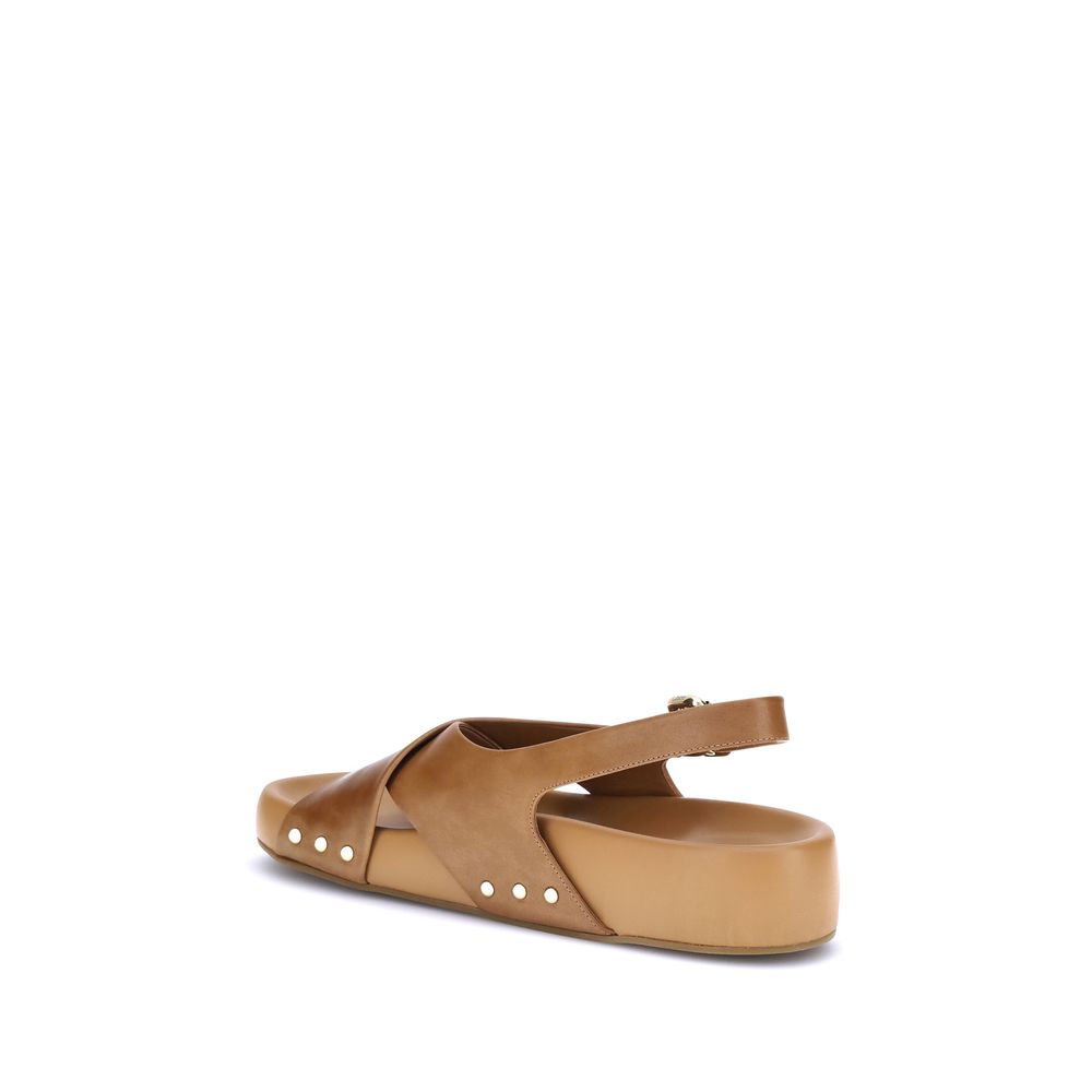 Mae SandalsThe Mae Sandals by Chloé, crafted from smooth calfskin, combine elegance and comfort thanks to the anatomical insole designed to last all day. The upper is characterized by crossed straps and an adjustable ankle strap, secured by the iconic Pad