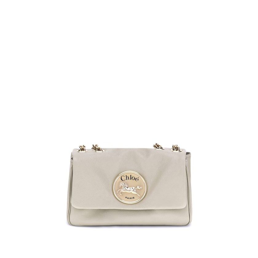 Beige Calf Leather Bos Taurus Shoulder BagChloé’s Heritage Shoulder Bag is a refined and versatile accessory made of soft grained leather. Its aesthetic is embellished with a metallic logo detail on the front, underscoring its design identity. The metal c