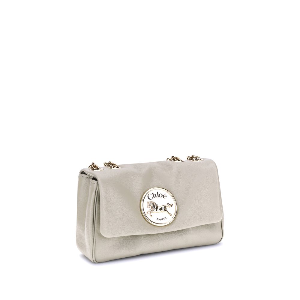 Beige Calf Leather Bos Taurus Shoulder BagChloé’s Heritage Shoulder Bag is a refined and versatile accessory made of soft grained leather. Its aesthetic is embellished with a metallic logo detail on the front, underscoring its design identity. The metal c