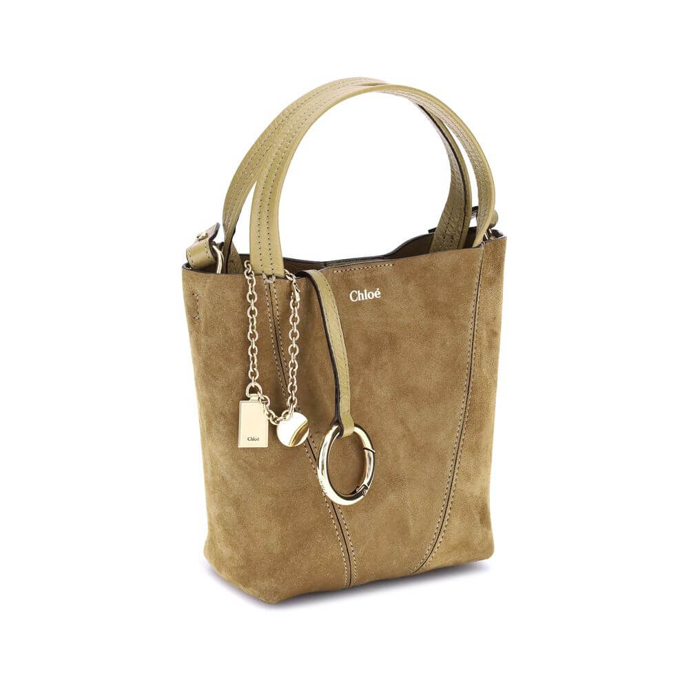 Beige Calf Leather Bos Taurus Shoulder BagThe Spin Handbag by Chloé, crafted from soft suede, stands out for its minimalist silhouette defined by clean graphic lines. A pendant chain with the Chloé and Horse medals, iconic symbols of the Maison, adds a re