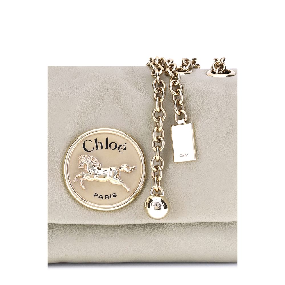 Beige Calf Leather Bos Taurus Shoulder BagChloé’s Heritage Shoulder Bag is a refined and versatile accessory made of soft grained leather. Its aesthetic is embellished with a metallic logo detail on the front, underscoring its design identity. The metal c