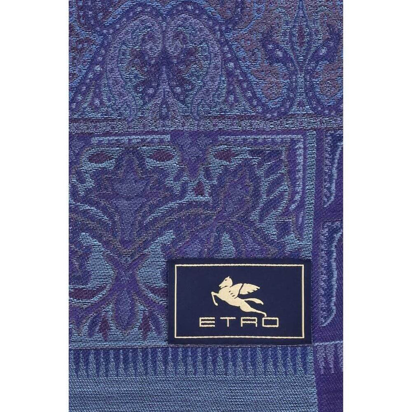 Blue Wool ScarfThe Etro jacquard wool and silk scarf is a refined accessory that combines quality and creativity. Distinguished by a particular abstract motif, it is enriched by a sartorial label with the Pegasus and the ETRO logo, iconic symbols of the M