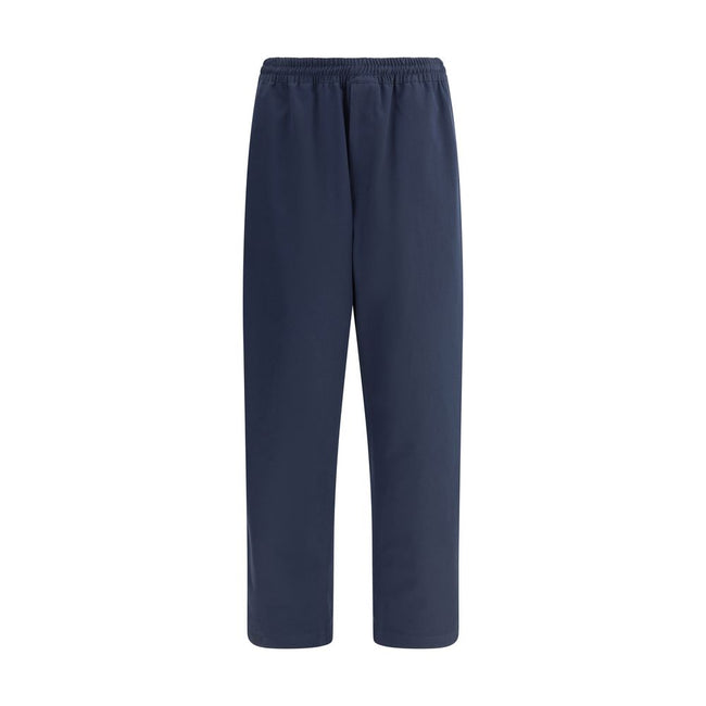 Blue Cotton Casual PantsPrada’s Cotton Pants combine comfort and style with an elasticized drawstring waistband and front zipper closure. They feature two side welt pockets and two patch pockets on the back, embellished with the iconic logo that adds a di