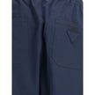 Blue Cotton Casual PantsPrada’s Cotton Pants combine comfort and style with an elasticized drawstring waistband and front zipper closure. They feature two side welt pockets and two patch pockets on the back, embellished with the iconic logo that adds a di