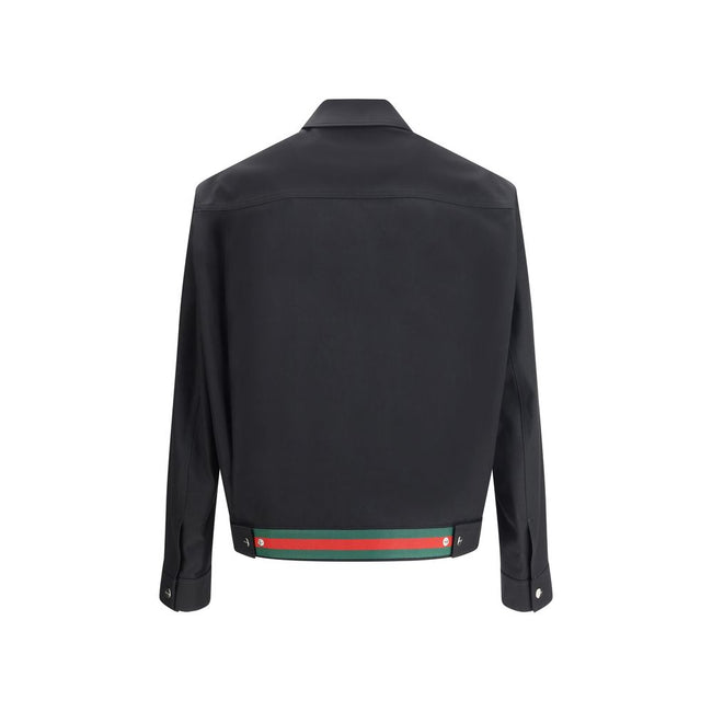 Black Cotton Shell JacketCotton Jacket by Gucci with classic collar and front zip closure. The model features two side welt pockets and adjustable cuffs with a button. The iconic multicolored stripes, a distinctive symbol of the Maison, stand out on the b