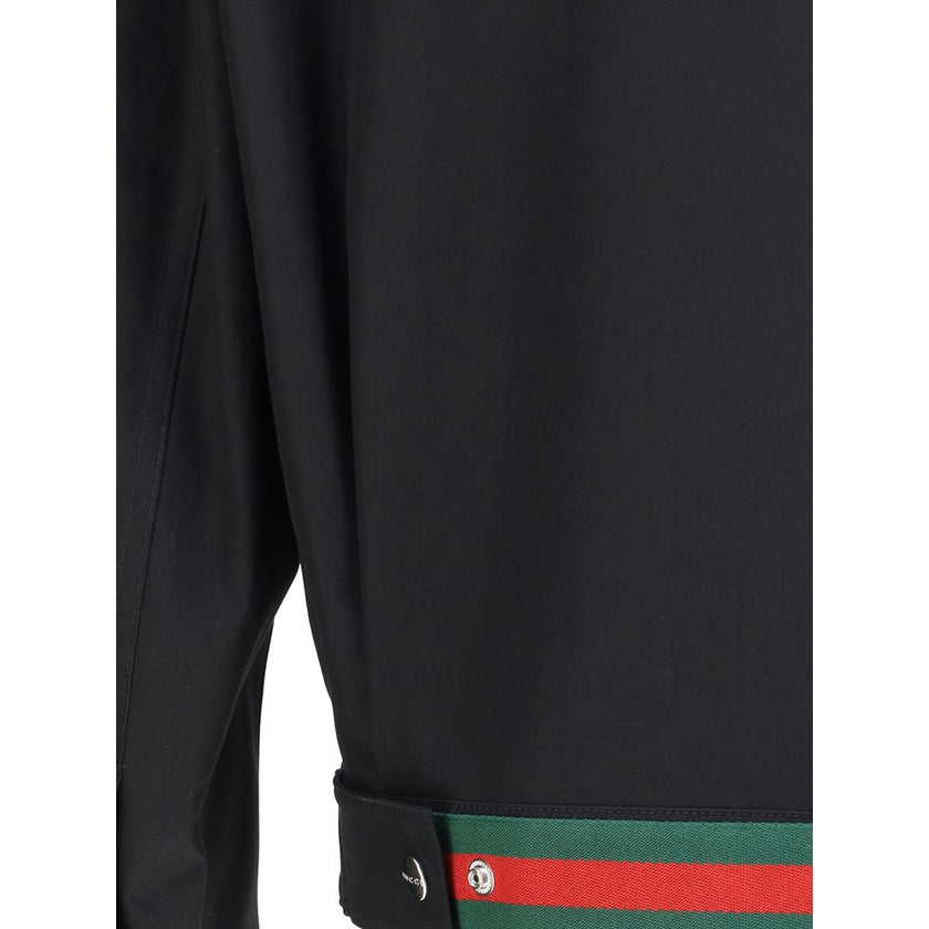 Black Cotton Shell JacketCotton Jacket by Gucci with classic collar and front zip closure. The model features two side welt pockets and adjustable cuffs with a button. The iconic multicolored stripes, a distinctive symbol of the Maison, stand out on the b