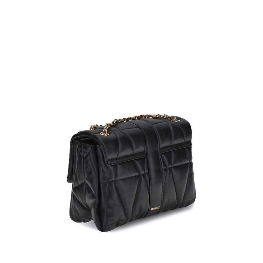 Black Calf Leather Bos Taurus Shoulder BagThe Kleio Shoulder Bag by Versace is crafted from soft quilted lambskin, embellished with the Medusa ’95 metal detail on the front, an iconic symbol of the Maison. The metal chain shoulder strap is versatile and c