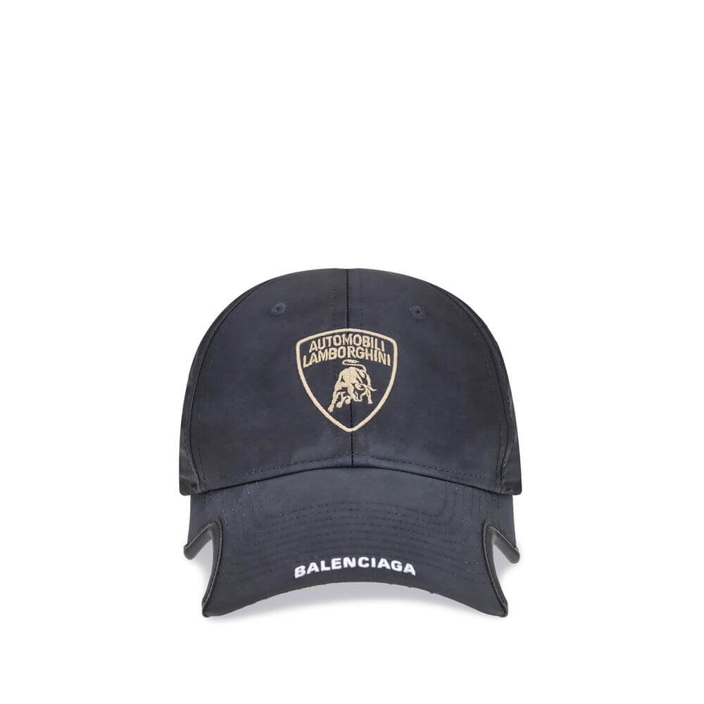 Black Cotton Cap (Baseball Hat)The Lamborghini x Balenciaga Baseball Cap is a bold accessory born from the collaboration between two icons of luxury and design. Featuring embroidered ventilation eyelets on the top, it has a distinctive cut-out visor on bo