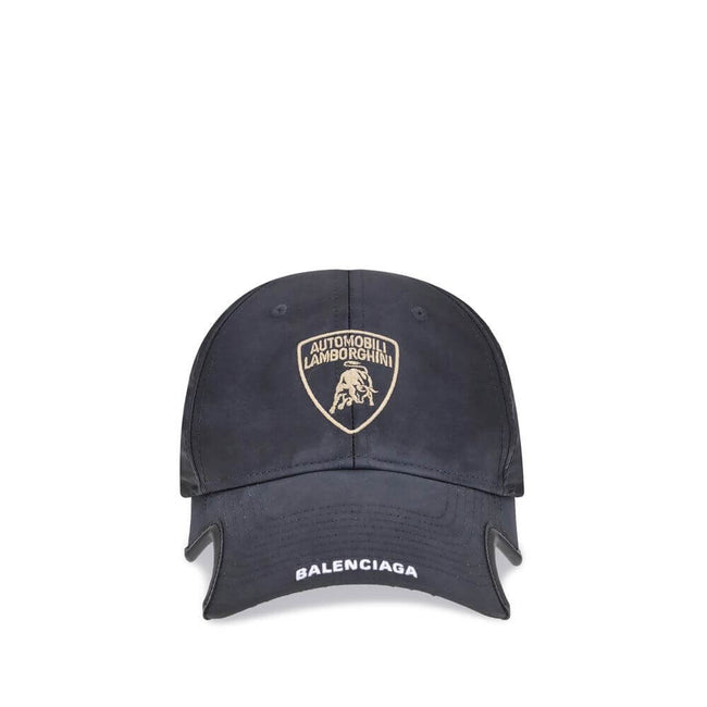 Black Cotton Cap (Baseball Hat)The Lamborghini x Balenciaga Baseball Cap is a bold accessory born from the collaboration between two icons of luxury and design. Featuring embroidered ventilation eyelets on the top, it has a distinctive cut-out visor on bo
