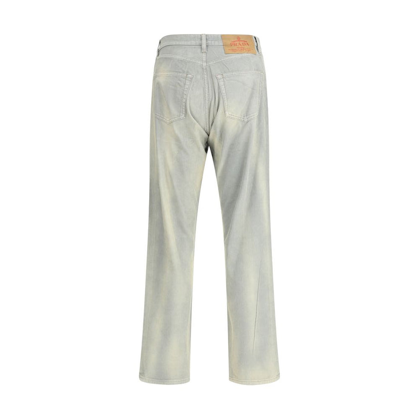 Light Blue Cotton Casual PantsFive-pocket Pants in cotton with a corduroy effect by Prada. The model features a front button fastening, belt loops at the waist and a logo patch applied on the back. The faded finish design gives the garment a lived-in and