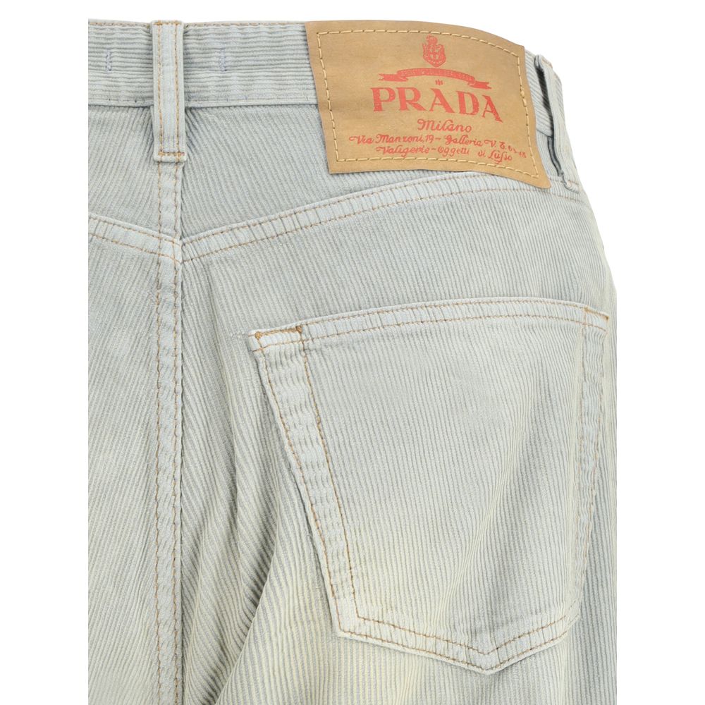 Light Blue Cotton Casual PantsFive-pocket Pants in cotton with a corduroy effect by Prada. The model features a front button fastening, belt loops at the waist and a logo patch applied on the back. The faded finish design gives the garment a lived-in and