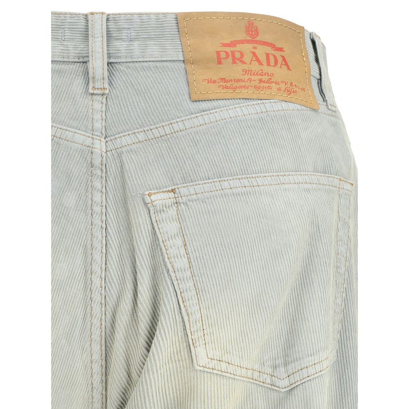 Light Blue Cotton Casual PantsFive-pocket Pants in cotton with a corduroy effect by Prada. The model features a front button fastening, belt loops at the waist and a logo patch applied on the back. The faded finish design gives the garment a lived-in and