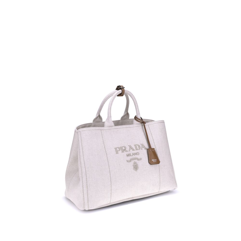 Cream Cotton Shoulder BagPrada’s extra large Jardinière Handbag combines elegance and functionality in a high-quality linen blend. Featuring two tubular handles and exposed topstitching, it has an adjustable and removable ribbon shoulder strap for differe