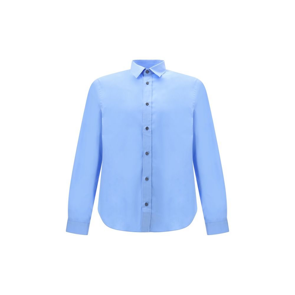 Light Blue Cotton Dress ShirtThe Prada Cotton Shirt is an essential piece with a refined style. Featuring a classic collar and front button closure, it stands out for the iconic signature sewn on the front, a discreet but unmistakable detail. Season: AW25
