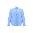 Light Blue Cotton Dress ShirtThe Prada Cotton Shirt is an essential piece with a refined style. Featuring a classic collar and front button closure, it stands out for the iconic signature sewn on the front, a discreet but unmistakable detail. Season: AW25
