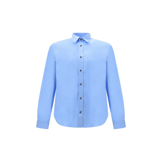 Light Blue Cotton Dress ShirtThe Prada Cotton Shirt is an essential piece with a refined style. Featuring a classic collar and front button closure, it stands out for the iconic signature sewn on the front, a discreet but unmistakable detail. Season: AW25