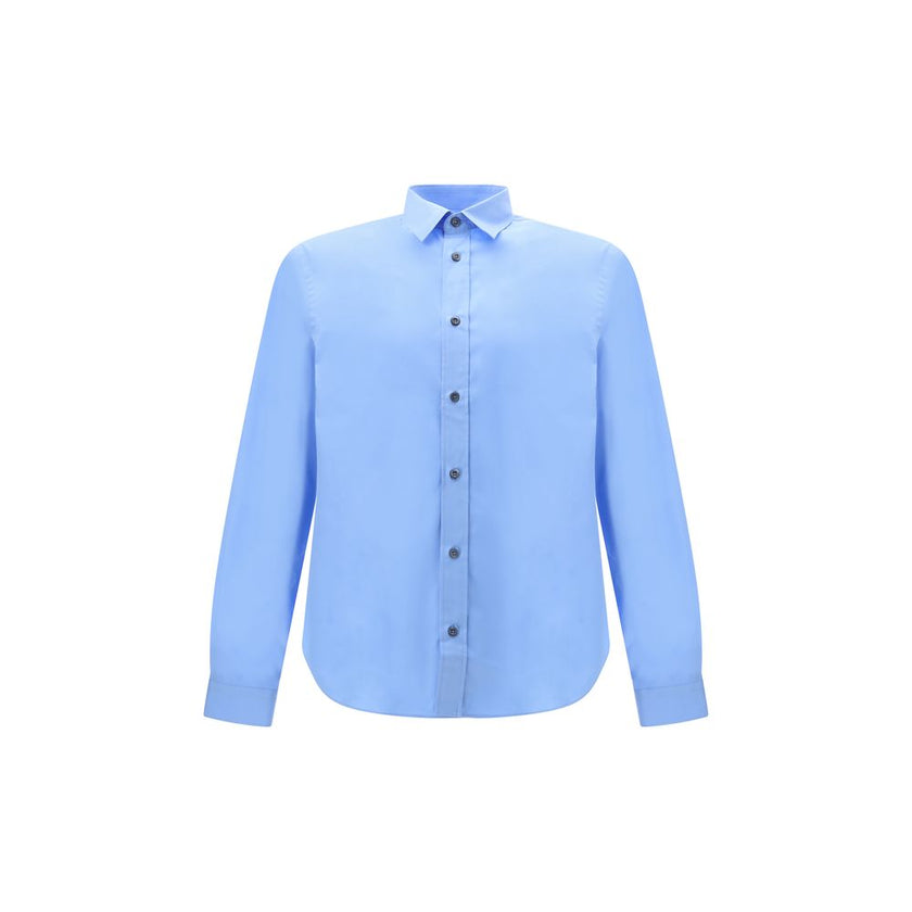 Light Blue Cotton Dress ShirtThe Prada Cotton Shirt is an essential piece with a refined style. Featuring a classic collar and front button closure, it stands out for the iconic signature sewn on the front, a discreet but unmistakable detail. Season: AW25