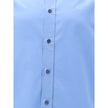 Light Blue Cotton Dress ShirtThe Prada Cotton Shirt is an essential piece with a refined style. Featuring a classic collar and front button closure, it stands out for the iconic signature sewn on the front, a discreet but unmistakable detail. Season: AW25