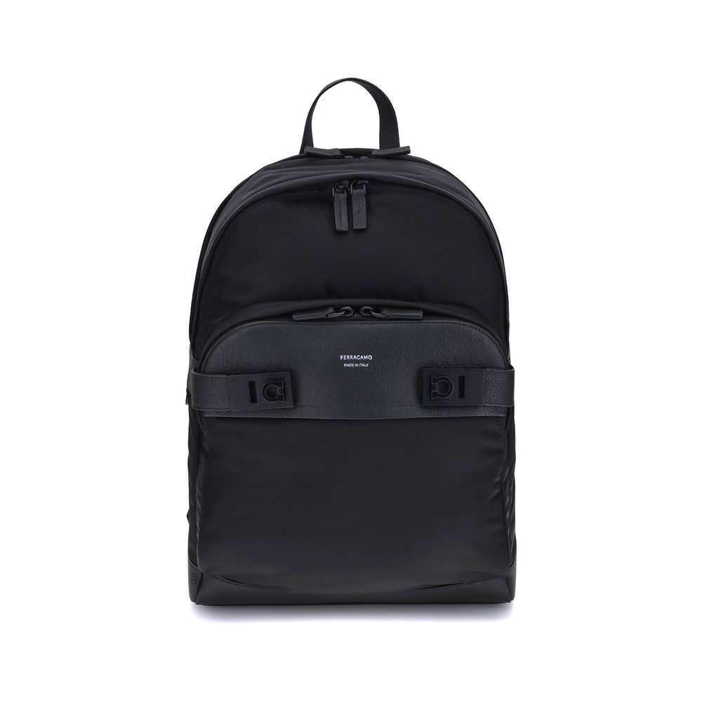 Black Nylon BackpackThe Ferragamo nylon Backpack combines functionality and style in a modern and refined design. Featuring a top zip closure and adjustable shoulder straps, it ensures practicality and comfort. The signature print on the front adds an ico
