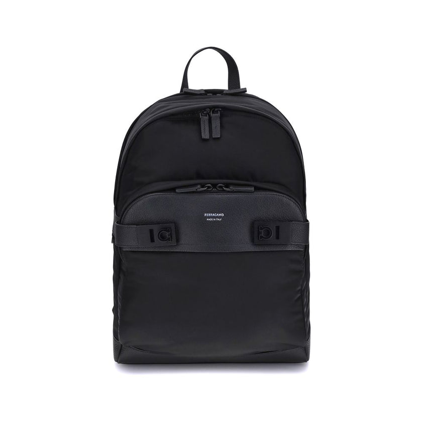 Black Nylon BackpackThe Ferragamo nylon Backpack combines functionality and style in a modern and refined design. Featuring a top zip closure and adjustable shoulder straps, it ensures practicality and comfort. The signature print on the front adds an ico