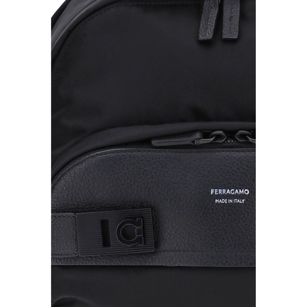 Black Nylon BackpackThe Ferragamo nylon Backpack combines functionality and style in a modern and refined design. Featuring a top zip closure and adjustable shoulder straps, it ensures practicality and comfort. The signature print on the front adds an ico