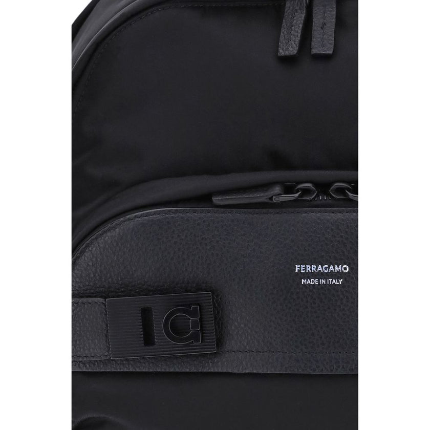 Black Nylon BackpackThe Ferragamo nylon Backpack combines functionality and style in a modern and refined design. Featuring a top zip closure and adjustable shoulder straps, it ensures practicality and comfort. The signature print on the front adds an ico